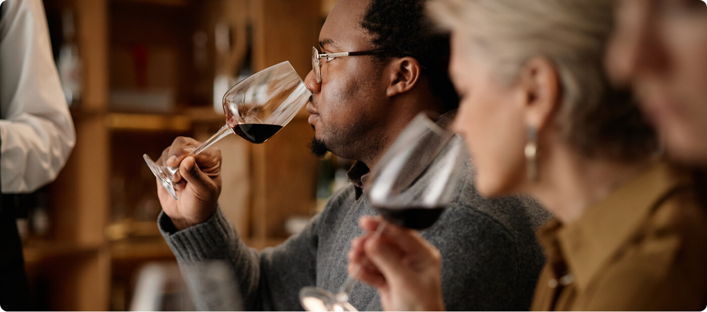 People tasting red Merlot wine