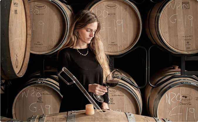 About WSJ Wine- hands holding grapes
