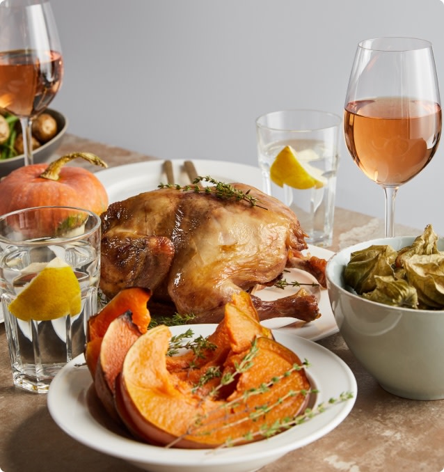 Glasses of rosé wine served with Thanksgiving turkey and side dishes
