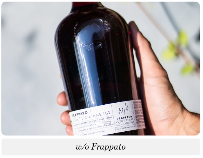 a hand holding a bottle of w/o Frappato Sicilian red wine
