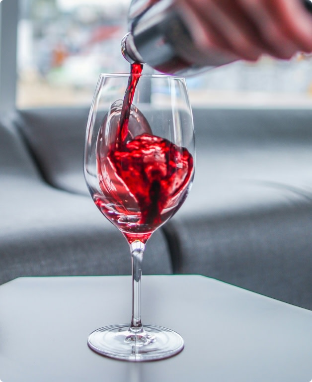 Pouring light red wine into a glass