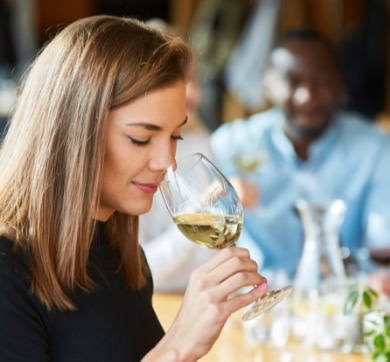 Woman smelling white wine at a tasting