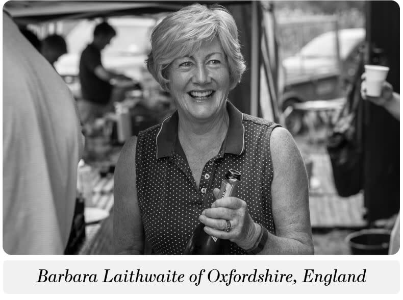 A photo of a woman holding a bottle of sparkling wine. The caption below reads: "Barbara Laithwaite of Oxfordshire, England"