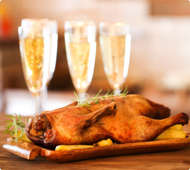 Roast duck paired with glasses of Champagne sparkling wine