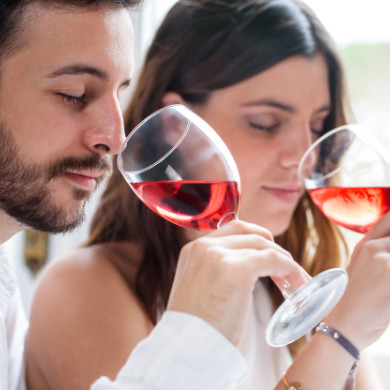 Two people sniffing wine at a wine tasting