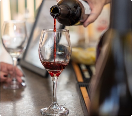 pouring a glass of dry red wine