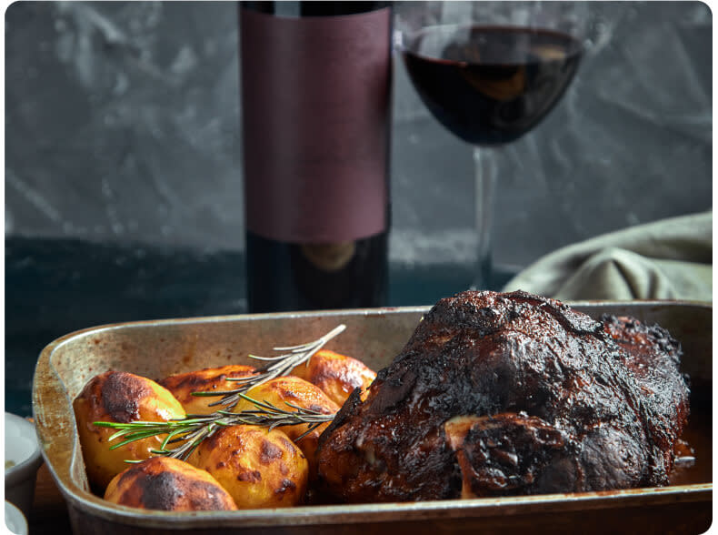 A glass of Merlot red wine paired with a roast meat dinner