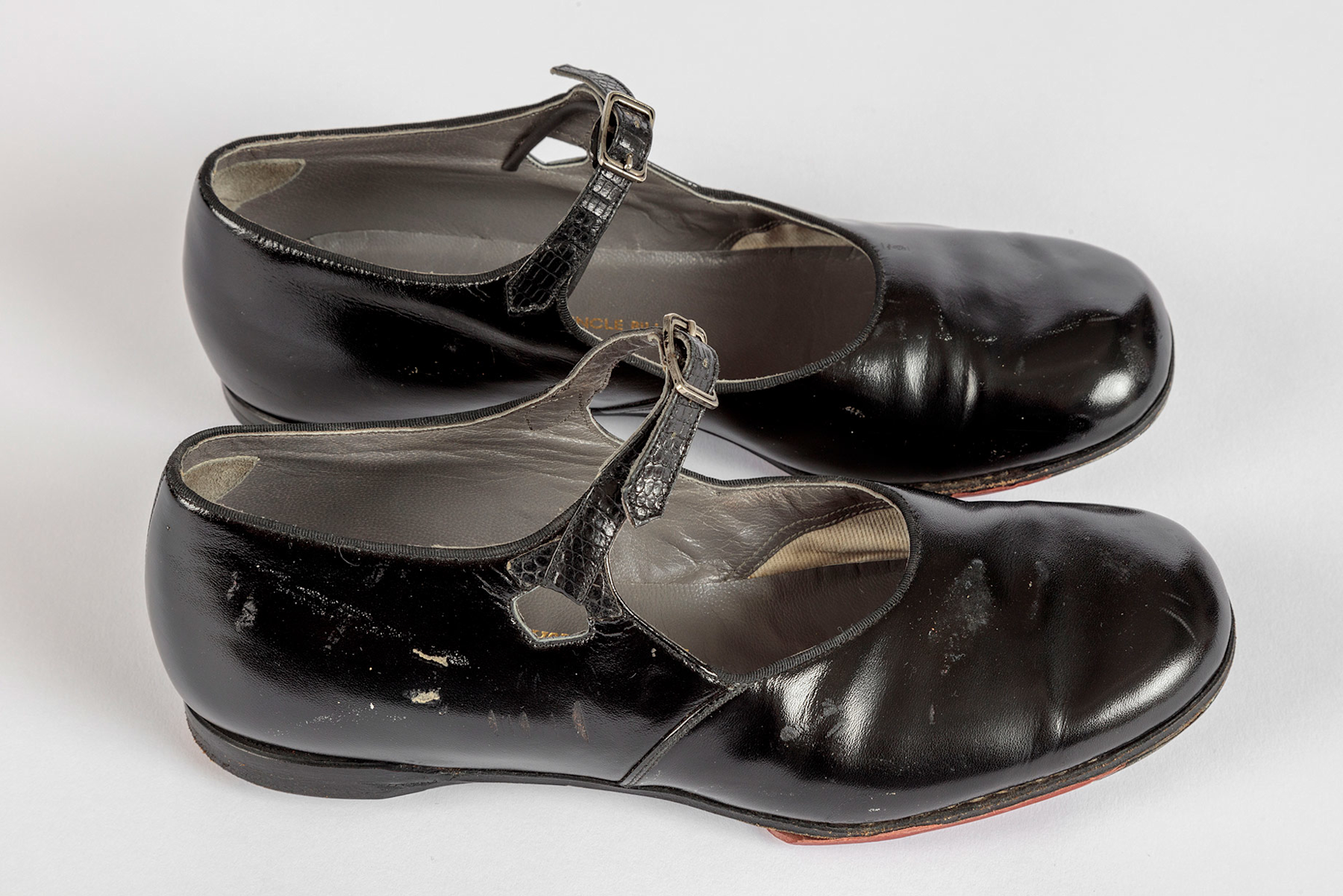  Shirley Temple's tap shoes and practice steps used during filming of <i>The Little Colonel</i> (1935).  Academy Museum of Motion Pictures, Gift of Shirley Temple Black and Family. Photo by Joshua White, JWPictures/©Academy Museum Foundation