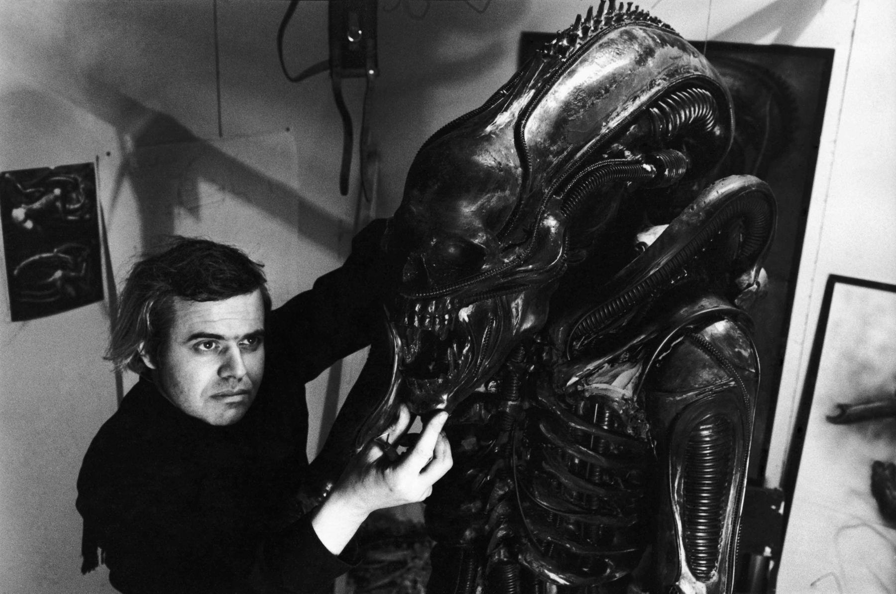 H. R. Giger working on a costume design during production of Alien (1979). H. R. Giger depicted on left. photographic print, gelatin silver. Courtesy Margaret Herrick Library, © Twentieth Century Fox