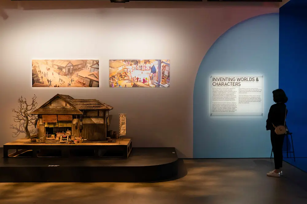 Women reading wall text and looking at model