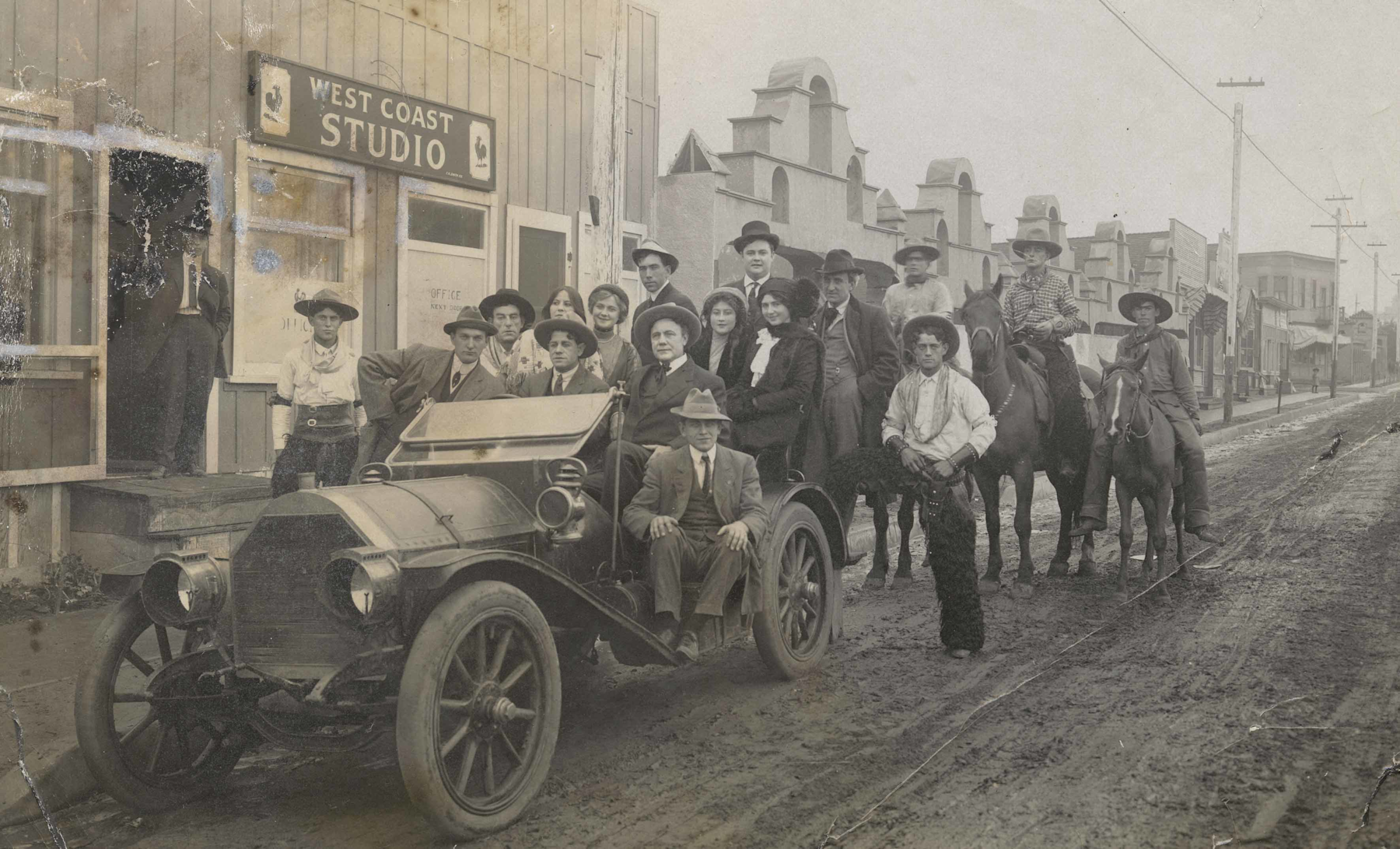 A group portrait of players, crew, and executives in front of Pathé Studios on Allesandro Street (now Glendale Boulevard) in the Edendale, Los Angeles, neighborhood, courtesy of Margaret Herrick Library, Academy of Motion Picture Arts and Sciences.