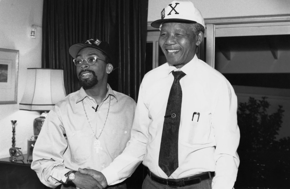 Director Spike Lee, left, and Nelson Mandela during production of Malcolm X (1992). Photo credit: David Lee. © Warner Bros.