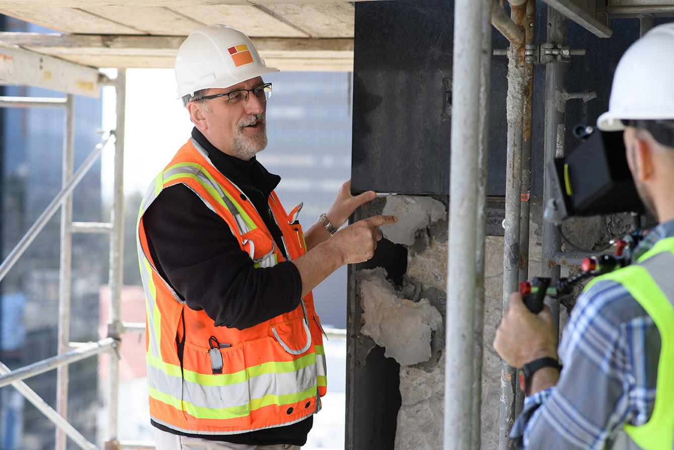 Restoration expert John Fidler with deteriorated building material removed from the former May Co. building at Wilshire and Fairfax being restored as the Academy Museum of Motion Pictures. ©Academy Museum Foundation
