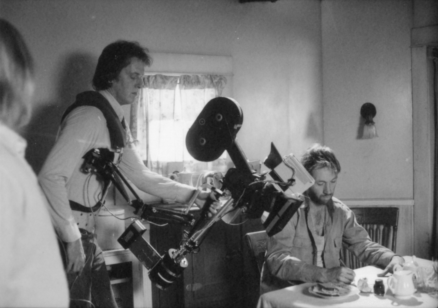 Steadicam operator Garrett Brown, second from left, and David Carradine, right, during production of <i>Bound for Glory</i> (USA, 1976). Metro-Goldwyn-Mayer/UA photographs, Margaret Herrick Library, Academy of Motion Picture Arts and Sciences.