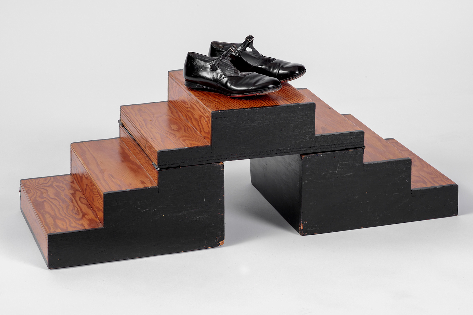 Shirley Temple's tap shoes and practice steps used during filming of <i>The Little Colonel</i> (1935). Academy Museum of Motion Pictures, Gift of Shirley Temple Black and Family. Photo by Joshua White, JWPictures/©Academy Museum Foundation
