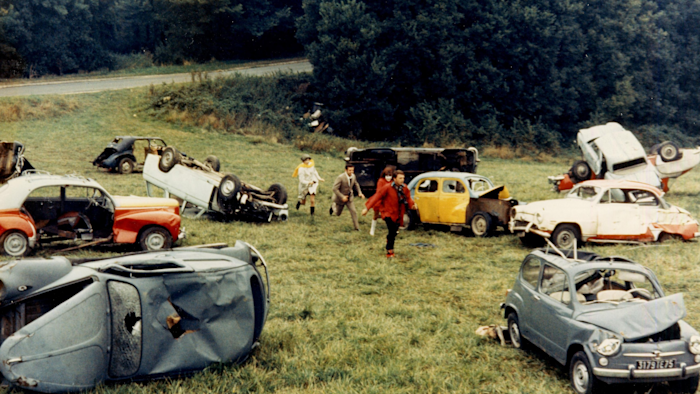 A bourgeois couple embarks on a dark, comic road trip through a collapsing world, encountering absurd violence and existential despair at every turn.