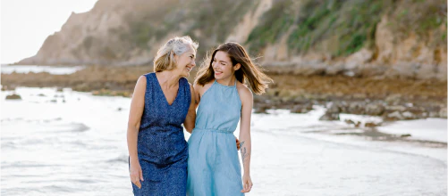 Two women walking in the sea