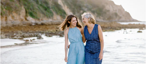 Two women walking in the sea