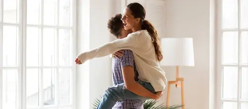 Woman and three children playing in the sea