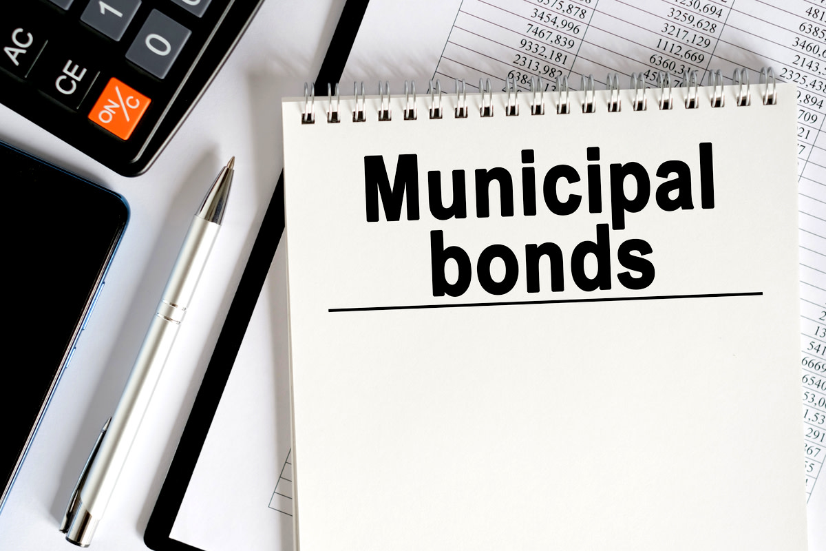 a calculator and a notebook with the inscription- Municipal bonds