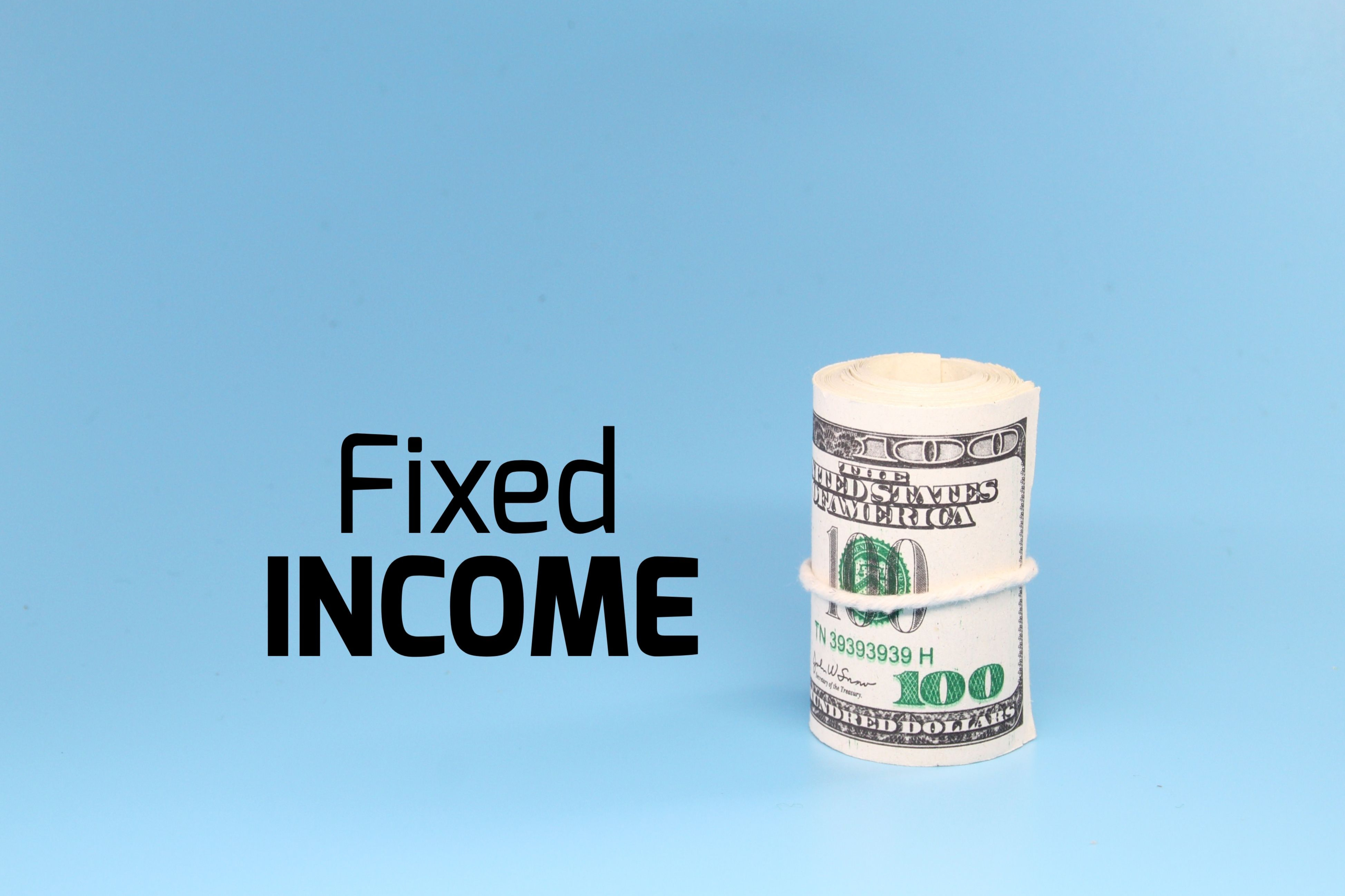 a roll of paper money with the word fixed income