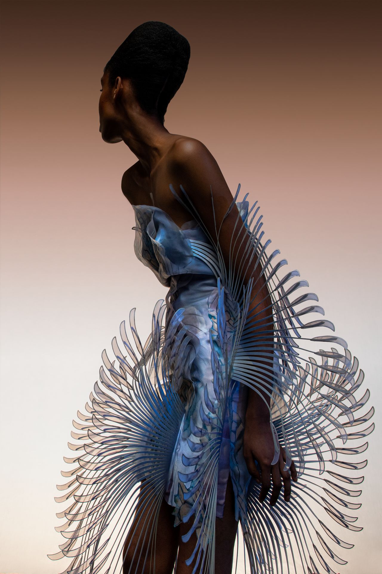 Woman wearing Iris van Herpen facing away from the camera.