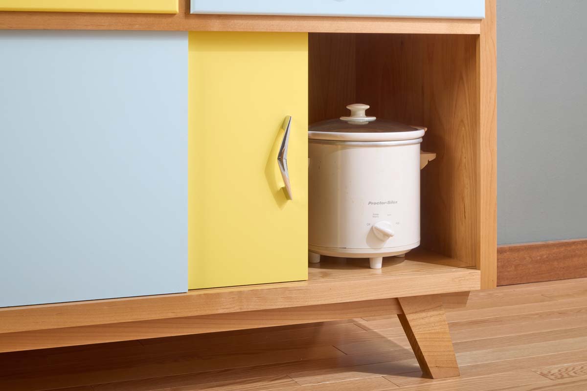 white rice cooker behind sliding door