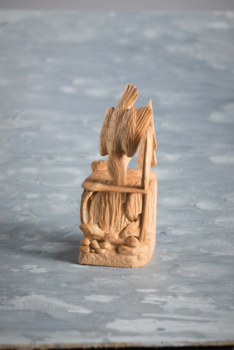 woodcarving of seagull diving
