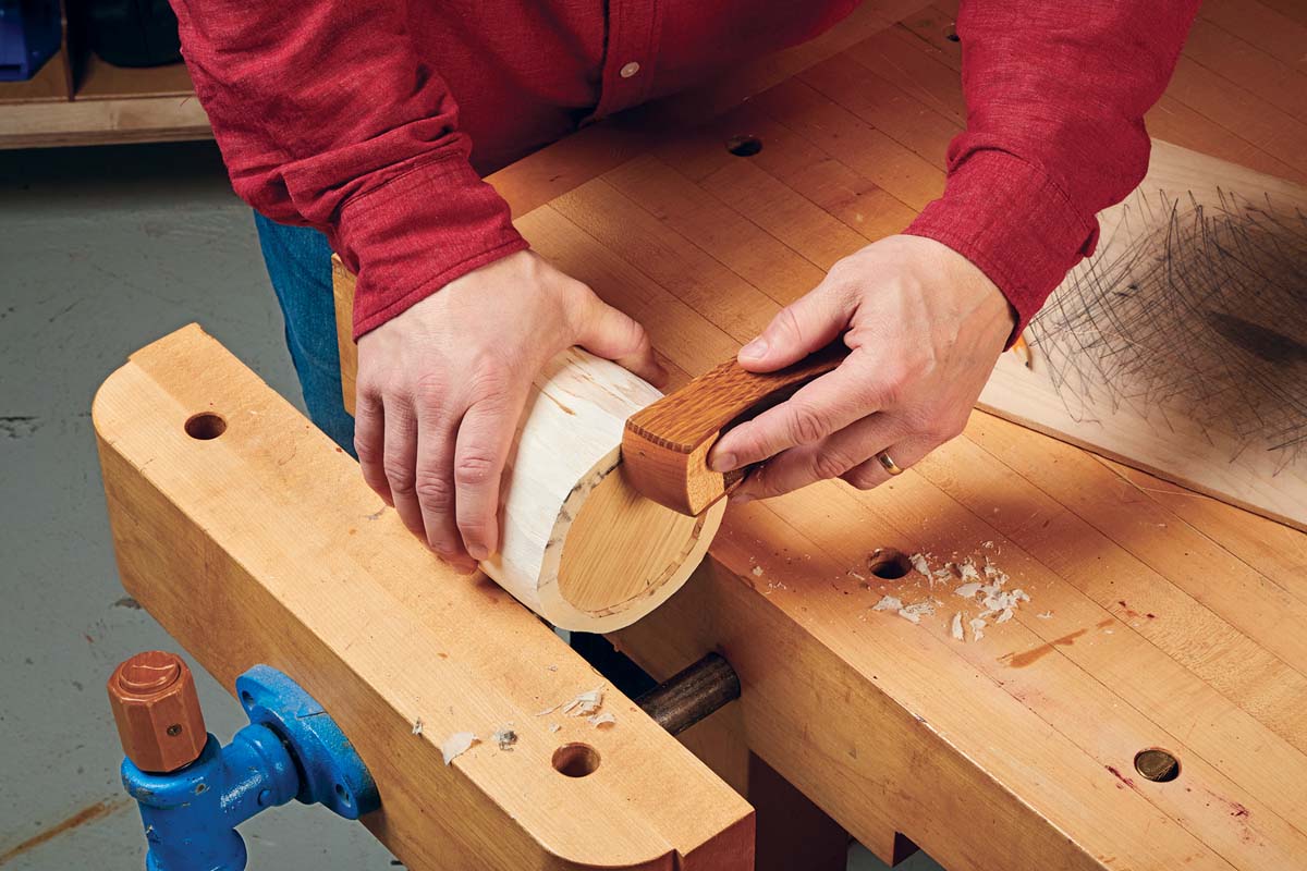 sanding off the dark marks on the wood canister bottom with block plane