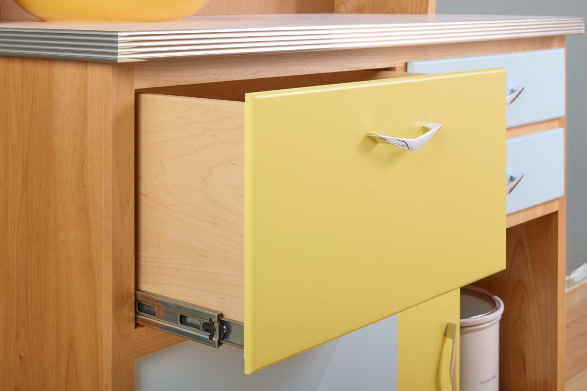 yellow drawer with metal slides and a front that conceal gaps