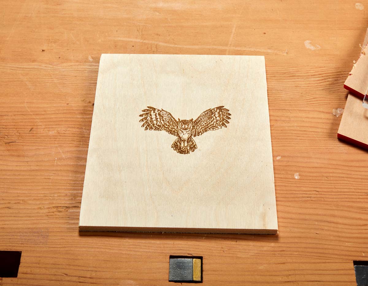 owl midflight engraved in wood