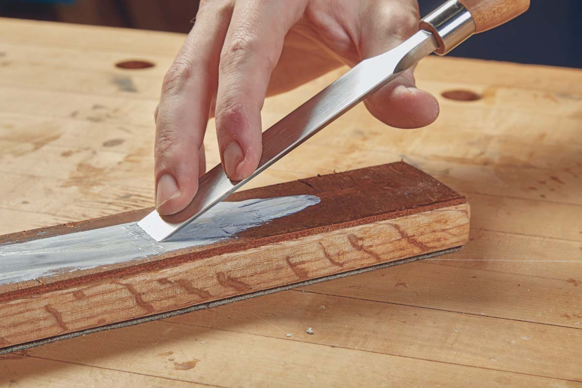 Step 3: pulling chisel backwards along strop with honing paste