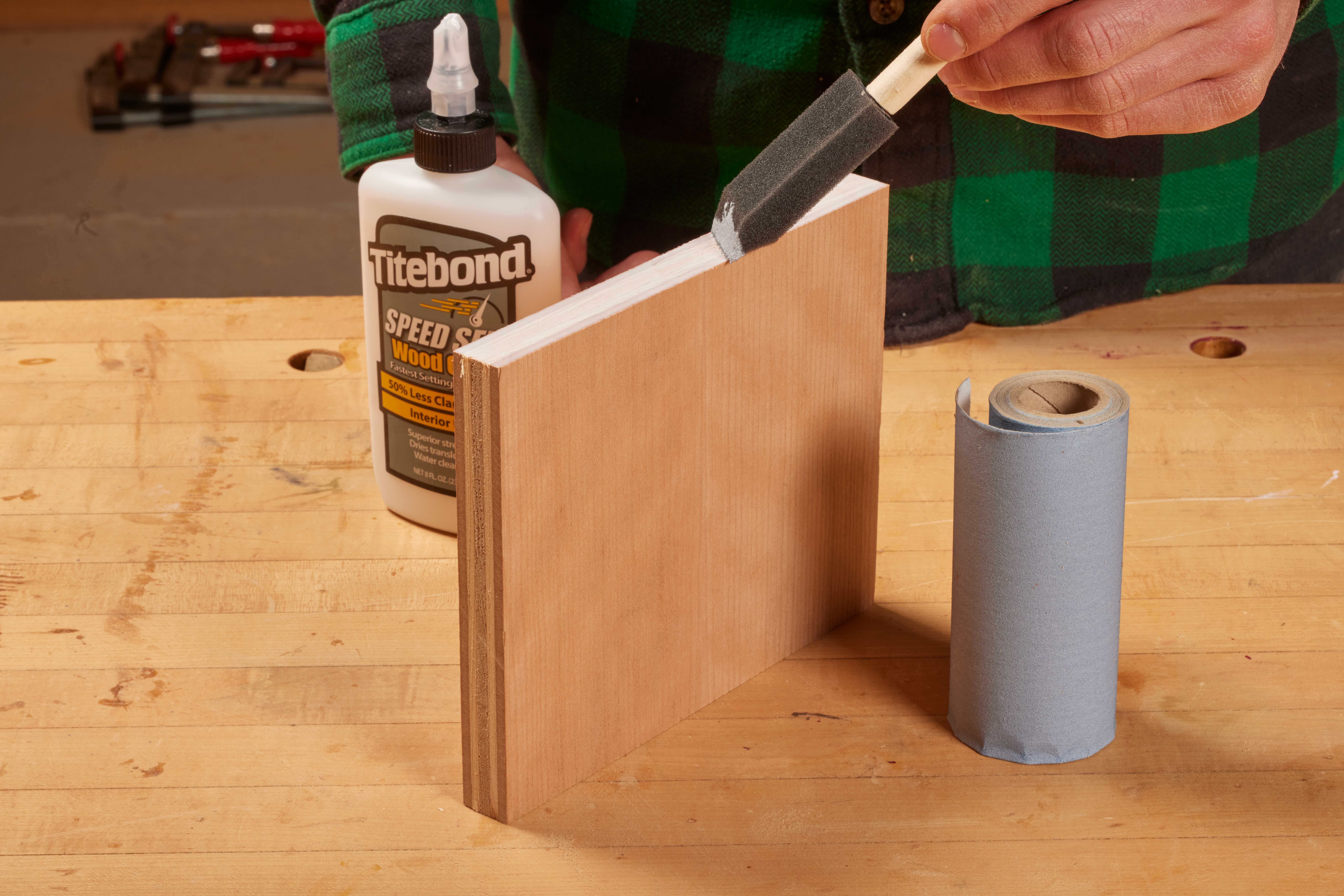 image shows sponge brush being used to seal the end of cabinet panel with resin or wood glue