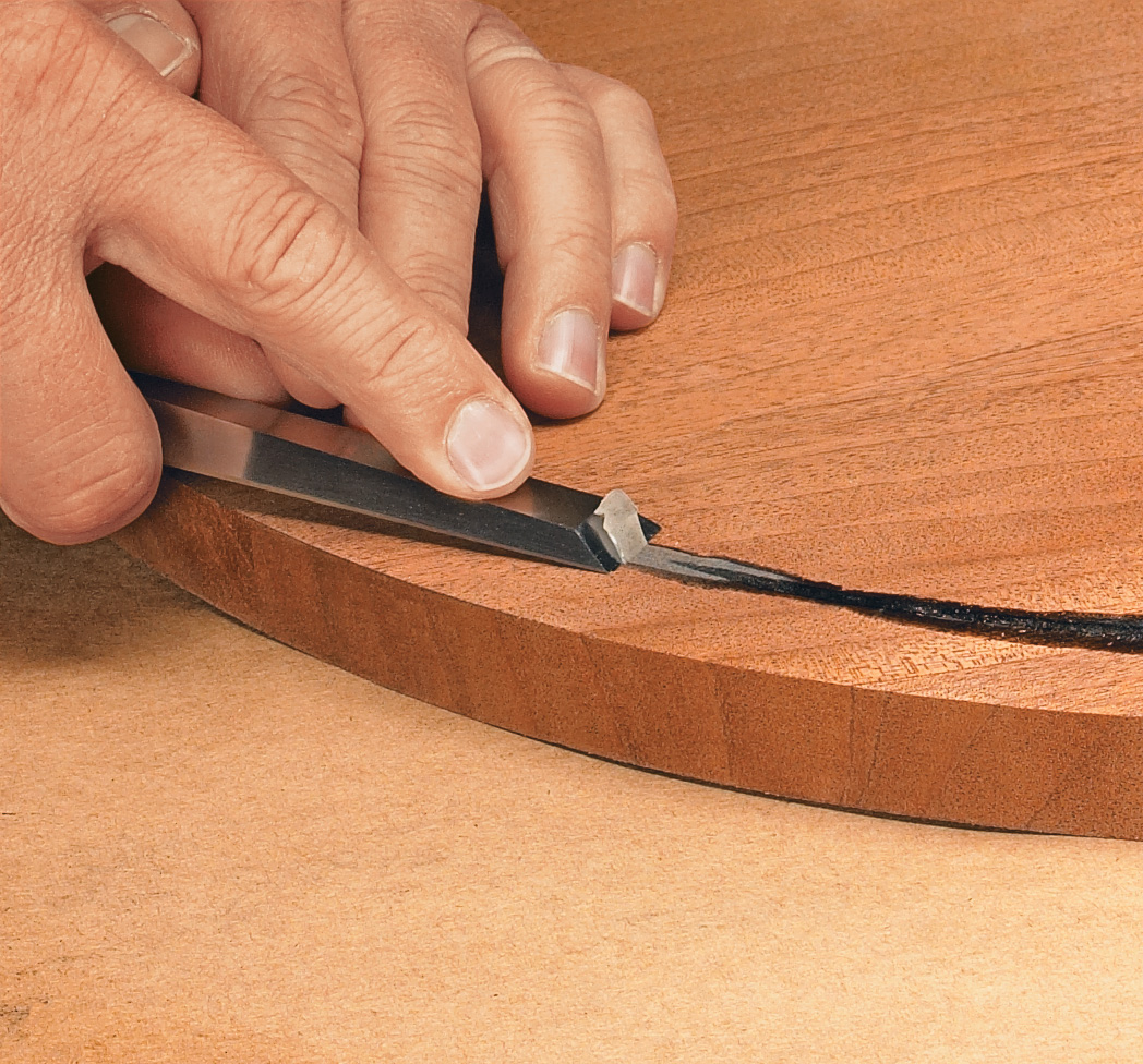 Using wood chisel to remove epoxy excess