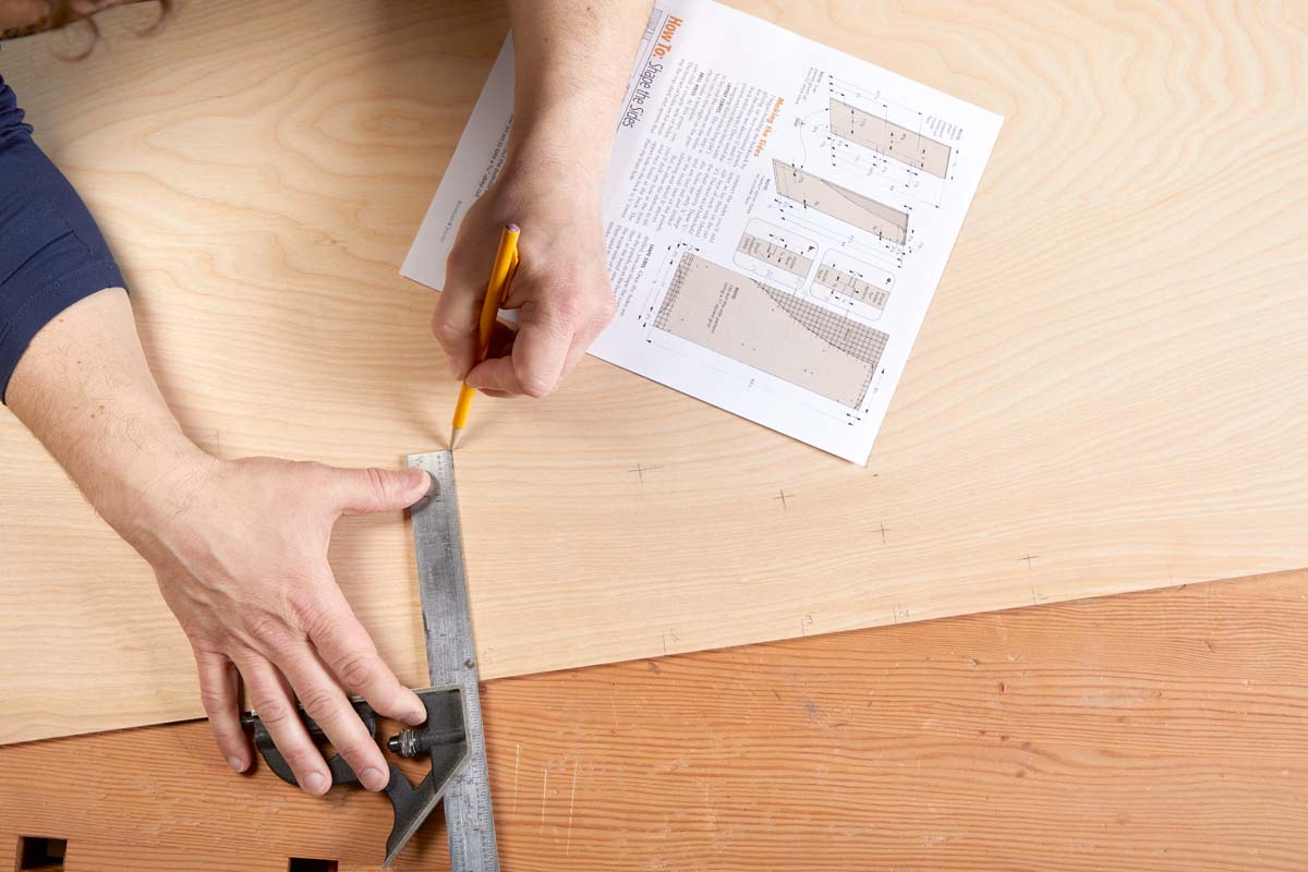 using ruler and square to mark where design will go in pencil