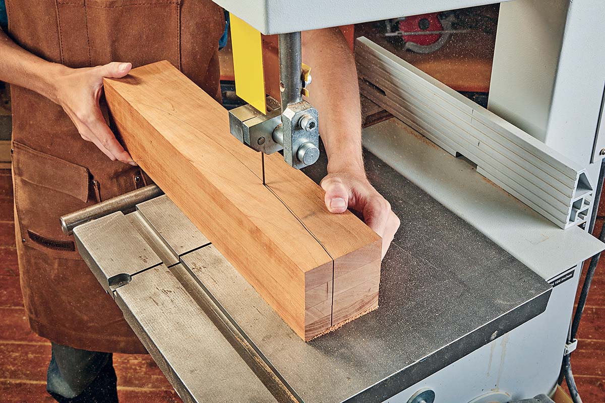 making second cut at bandsaw using tape to secure workpiece