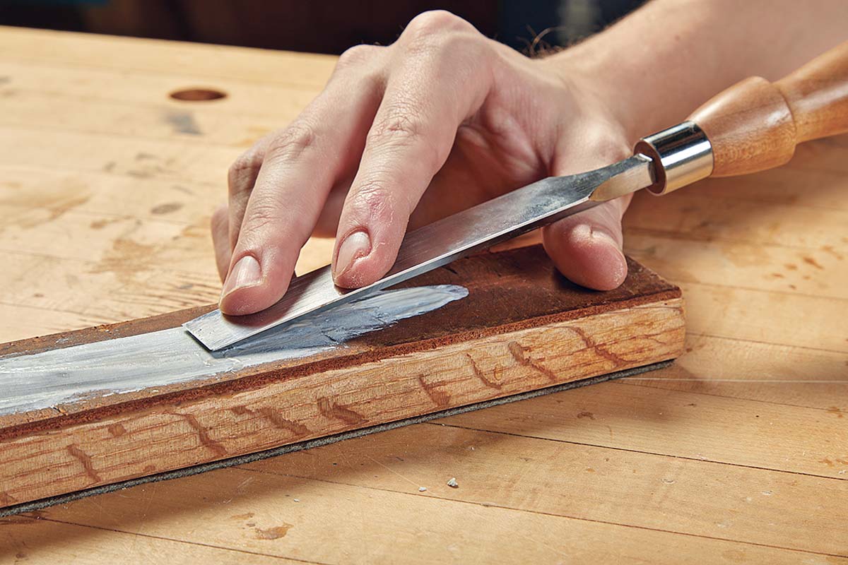 Step 2: running chisel along strop with honing paste