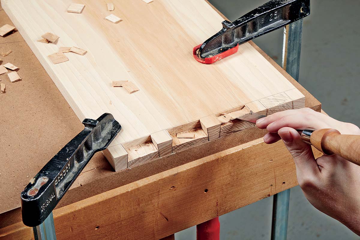 removing dovetail waste with chisel