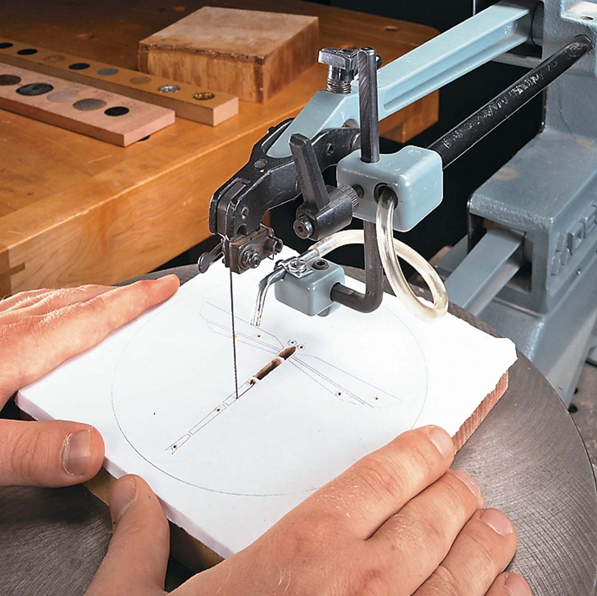 Cutting out dragonfly image in wood with band saw