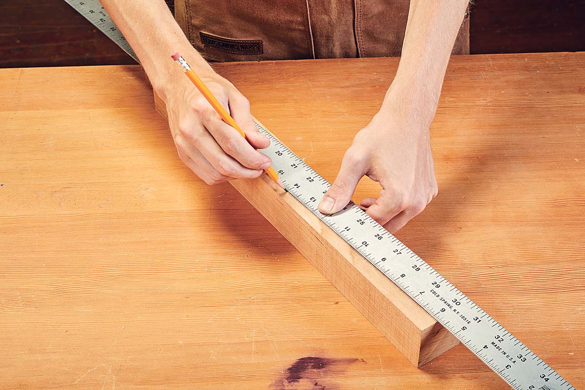 measuring taper with metal ruler and marking it with pencil