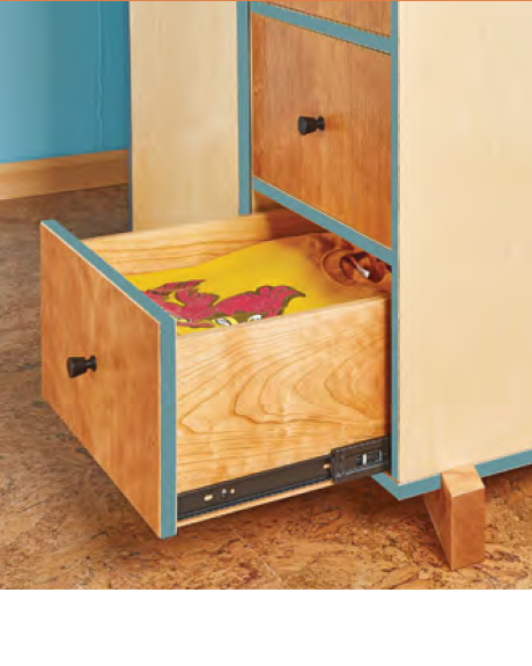 Image of natural wood dresser with the edges painted teal blue