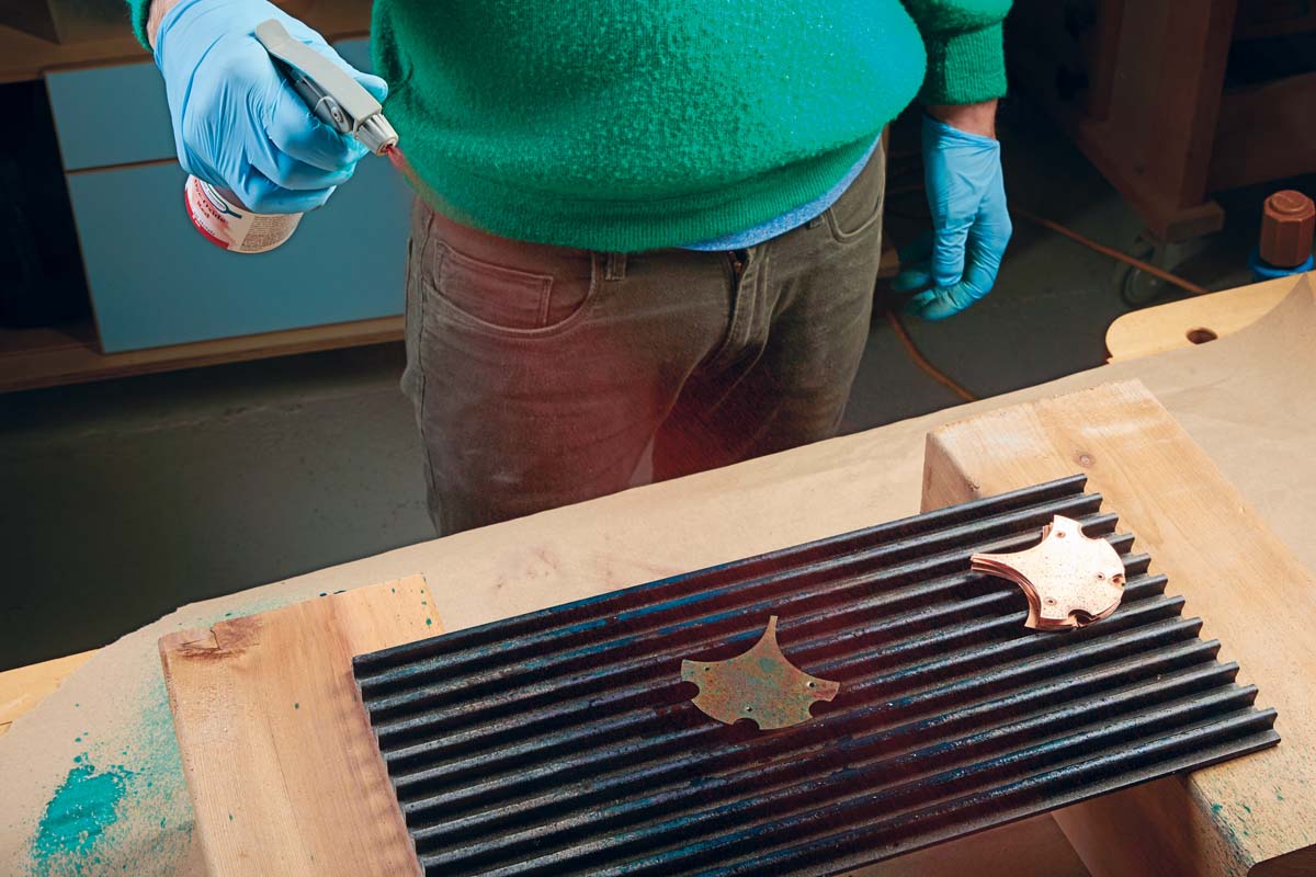 spraying dye-oxide red on copper ginkgo leaf