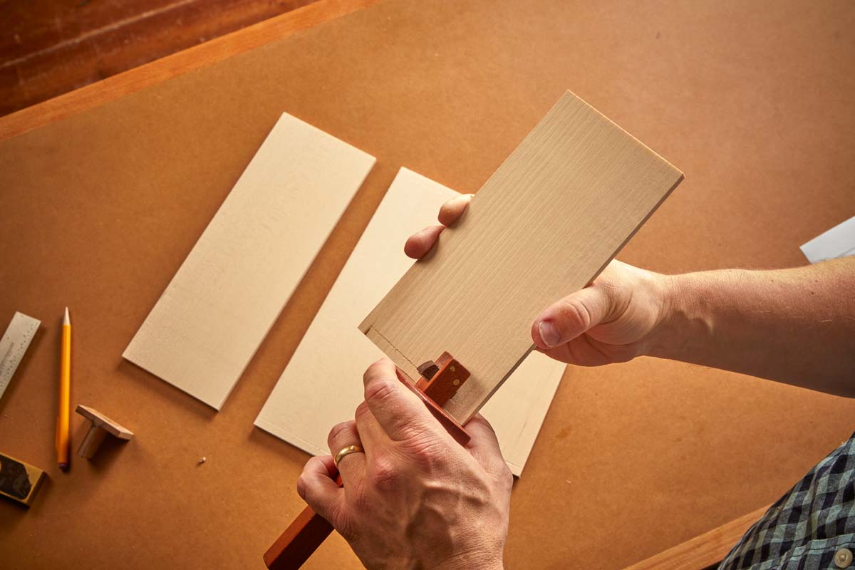 use marking gauge to scribe in baselines on the wood for where dovetails go