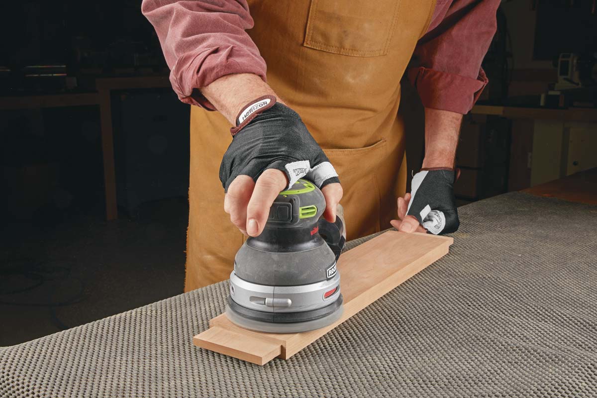 using random orbit sander with vibration-absorbing gloves