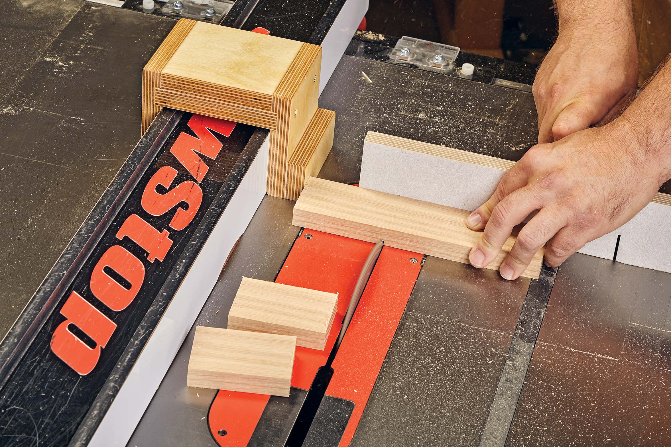 Using the self-clamping scrap block attached to rip fence on table saw