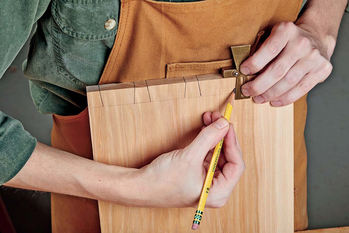 using bevel gauge and pencil to mark tails