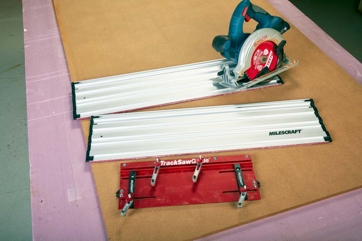 Milescraft Track Saw Guide and its auxiliary baseplate, two sections of track, and a pair of clamps