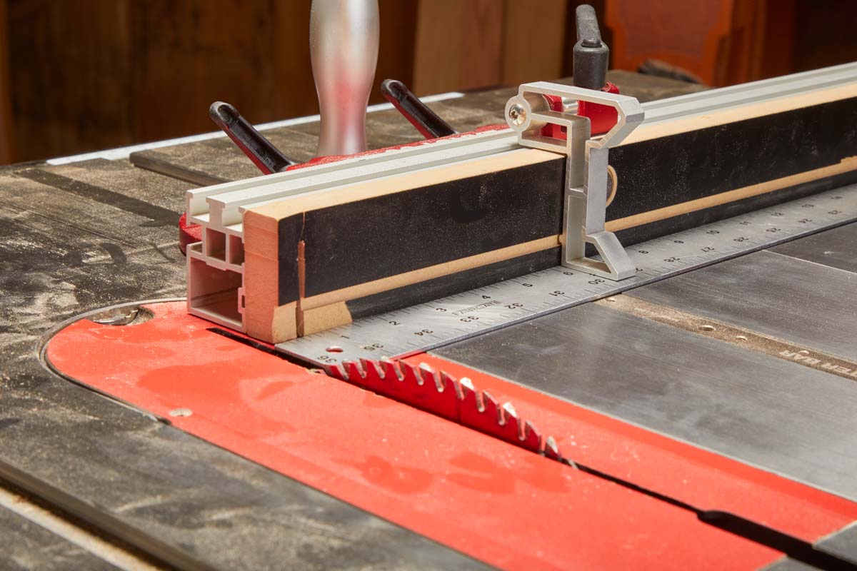 uisng long metal ruler to brace against table saw