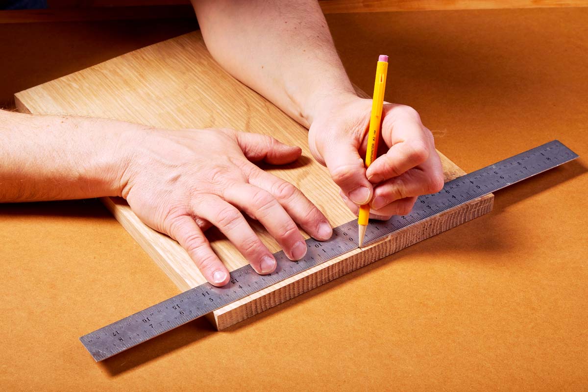 using centering scale on metal ruler to make pencil marks