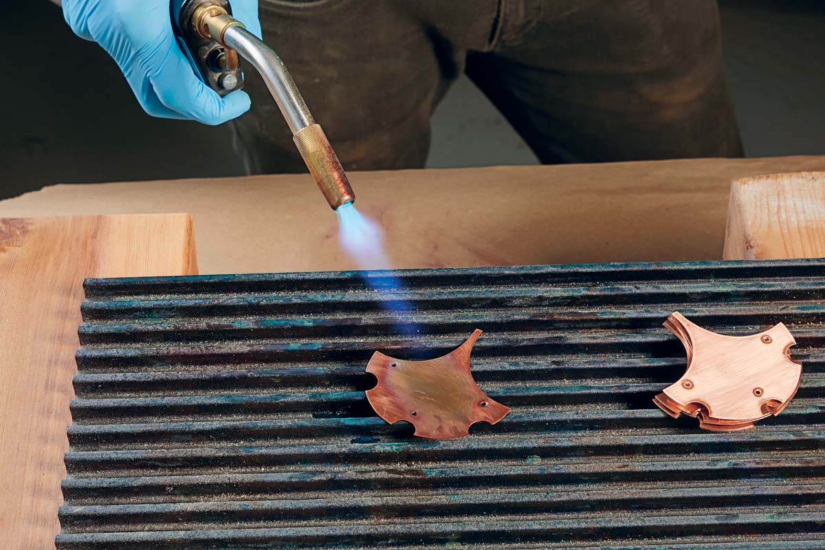 heating copper piece with blowtorch